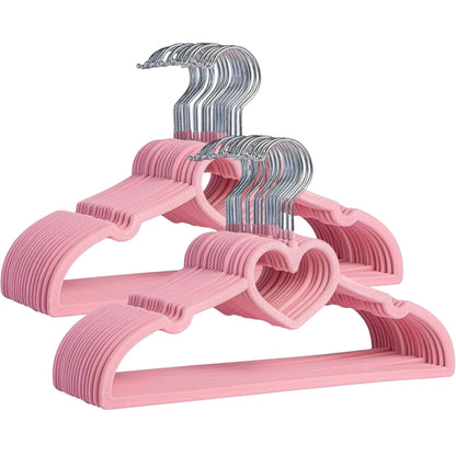 Set of pink velvet hangers with chrome hooks on a white background