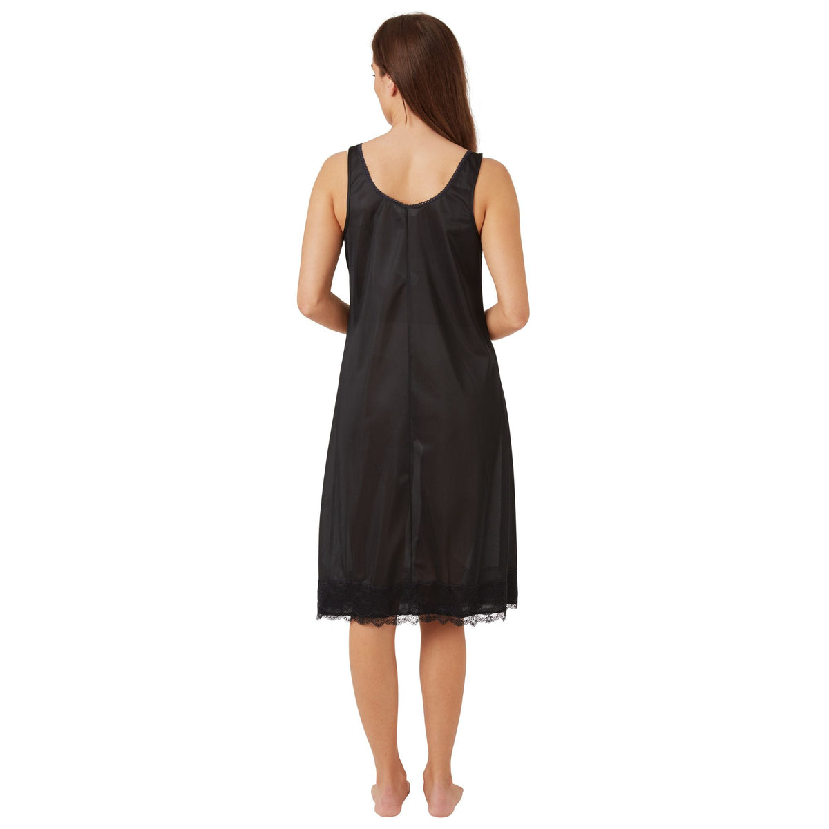 Woman wearing a black satin nightgown full slip on a white background