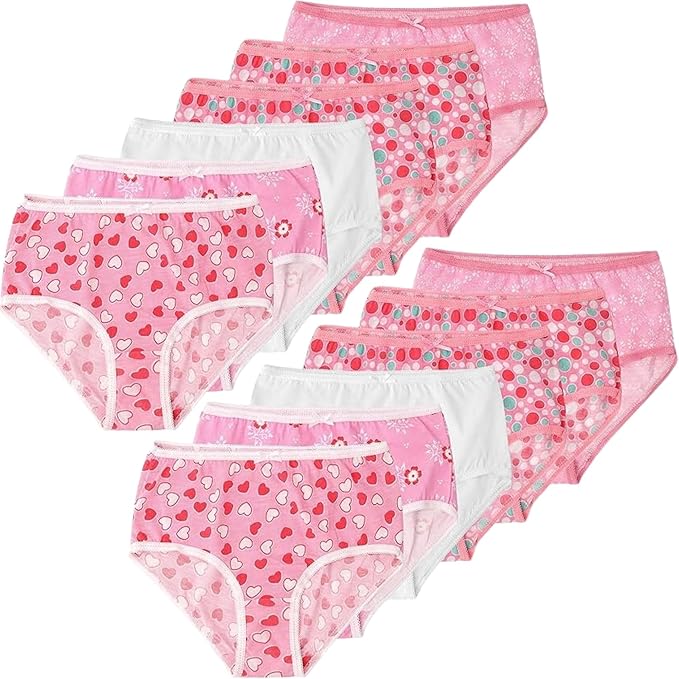 Set of pink girls' underwear with heart patterns on a white background