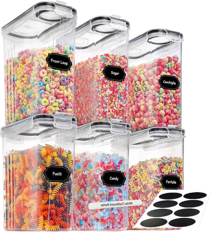 Set of clear storage containers with colorful snacks and labels on a white background